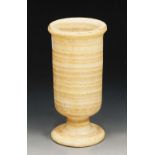 AN ALABASTER URN, of cylindrical form, with pedestal foot, 20.5cm high