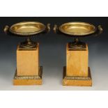 A PAIR OF 19TH CENTURY ITALIAN BRONZE CAMPANA URNS of classical form on Sienna marble plinths and