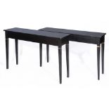 A PAIR OF BLACK PAINTED RECTANGULAR PIER TABLES on fluted tapering legs with carved foliate