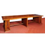 AN ITALIAN STYLE WALNUT LIBRARY TABLE of large proportions, the rectangular top supported by stile