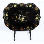 A VICTORIAN PAPIER MÂCHÉ TRAY TABLE with folding top and mother of pearl and painted decoration,