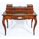 A 19TH CENTURY FRENCH BURR WALNUT AND ORMOLU MOUNTED SERPENTINE WRITING TABLE, the galleried super-