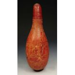 A PERUVIAN GOURD, circa 1930, incised with bands of figures and animals, 42cm high.