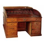 A 19TH CENTURY MAHOGANY TAMBOUR WRITING DESK attributed to Gillow, the interior fitted nine pigeon