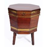 A GEORGE III MAHOGANY AND BRASS BOUND OCTAGONAL WINE COOLER with lead lined interior, hinged