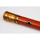 A GEORGIAN GOLD TOPPED MALACCA WALKING CANE, embossed and engraved with ribbon tied swags, maker I.