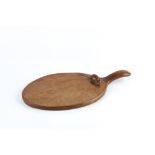 Robert Thompson of Kilburn (1876-1955) Mouseman cheese board, circa 1940 oak, oval shaped board