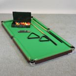 A snooker table, 180 x 93cm, with cues,