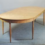 A 19th century Biedermeier style maple oval dining table, with three additional leaves,