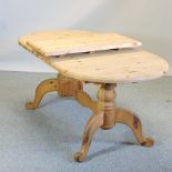 A pine twin pedestal extending dining table, with an additional leaf,