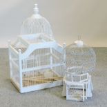 A white painted wooden bird cage, together with another,