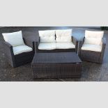 A suite of woven garden furniture, comprising a sofa, 127cm, a pair of armchairs and a table,