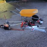 A petrol hedge cutter, together with a petrol garden multi cutter, a wicker armchair,