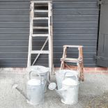 A wooden step ladder, together with another smaller, a galvanised watering can,