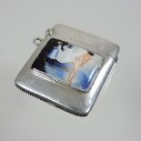 A silver and enamel vesta, painted with a nude figure,