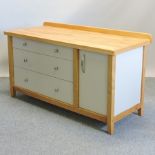 A beech kitchen unit, containing three drawers and a cupboard,