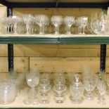 Two shelves of early 20th century and later drinking glasses