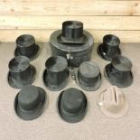 A collection of gentlemen's hats, to include a top hat,