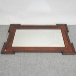 An Edwardian mahogany and inlaid wall mirror,