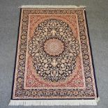A Keshan style carpet on a blue ground,