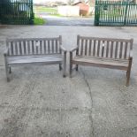 A near pair of wooden slatted garden benches,