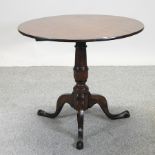 A George III oak tilt top occasional table,