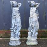 A pair of reconstituted stone garden figures of ladies,