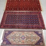 A Bokhara rug, with all over designs, on a red ground, 195 x 105cm,
