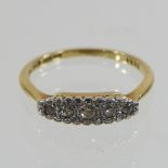 An 18 carat gold boat shaped five stone diamond ring