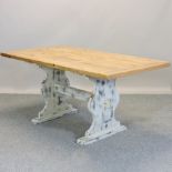 A rustic pine and painted dining table, on a trestle base,