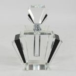 A large black glass fan shaped perfume bottle