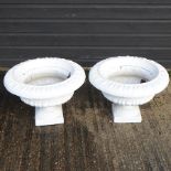 A pair of white painted campana shaped garden urns,