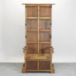 An early 20th century light oak hall stand,