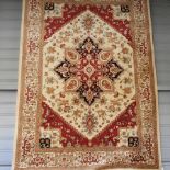 A Heriz style carpet, with a central medallion, on a cream ground,