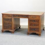 A reproduction yew wood pedestal partner's desk,