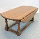 An oak drop leaf coffee table,