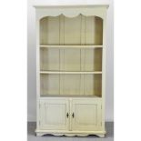 A modern cream painted open bookcase,