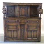 An early 20th century carved oak court cupboard,