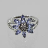 A 9 carat white gold topaz and diamond ring,