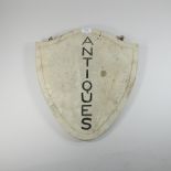 A painted wooden 'Antiques' sign,