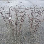 A collection of five metal garden plant supports,