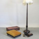 An early 20th century stained wooden standard lamp, 165cm, together with a suitcase,