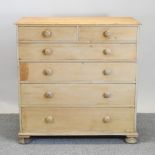 An early 20th century stripped pine chest of drawers,