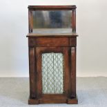 A Victorian rosewood chiffonier, with a mirrored back and grille door,