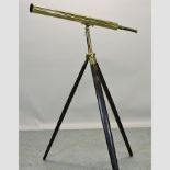 A 19th century brass cased telescope, on a wooden stand,