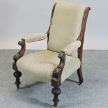 A Victorian cream upholstered and carved mahogany armchair,