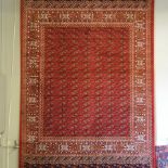A Bokhara style carpet, on a red ground,