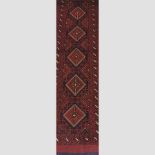 A Turkish woollen runner, with five central medallions, on a red ground,