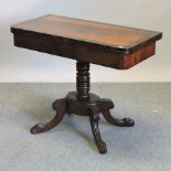 A Victorian mahogany and rosewood tea table, on a turned column and carved splayed base,