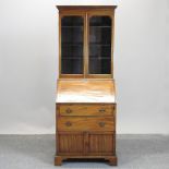 An Edwardian mahogany glazed bureau bookcase, on bracket feet,